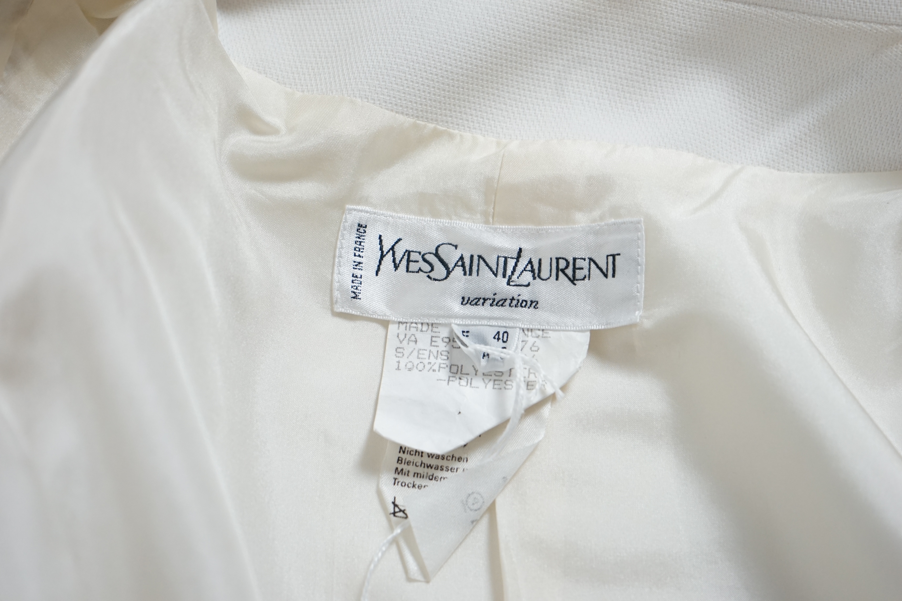 A vintage Yves Saint Laurent variation lady's off white three piece trouser suit with skirt (four pieces), F 40 (UK 12). Proceeds to Happy Paws Puppy Rescue